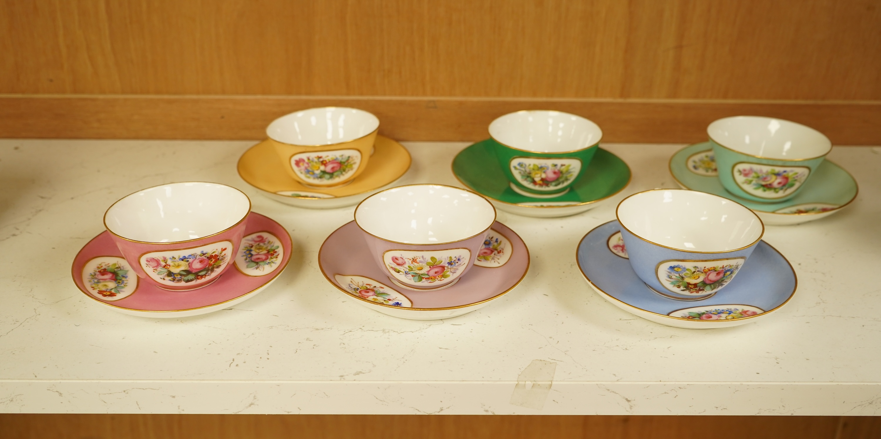 A Sevres style harlequin tea service for six, each saucer 13cm in diameter